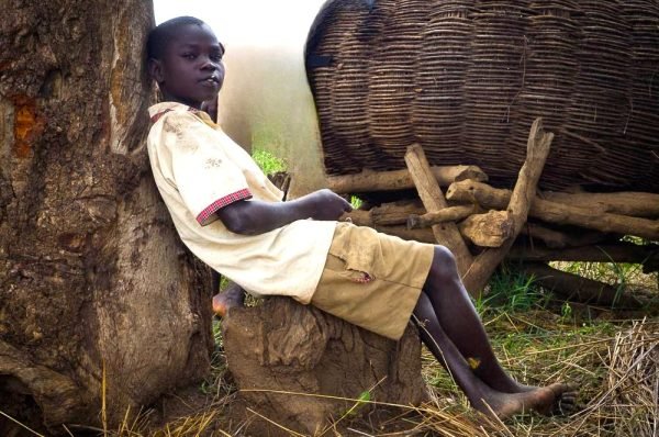 Boy sitting at a tree